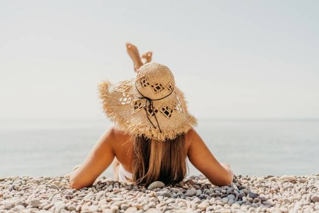 Beach Relaxation woman lies on a pebble beach, legs raised, and arms spread out. The concept of travel, vacation at sea Beach Relaxation woman lies on a pebble beach, legs raised, and arms spread out. The concept of travel, vacation at sea., model released, , property released, , 63305720.jpg RECORD DATE NOT STATED