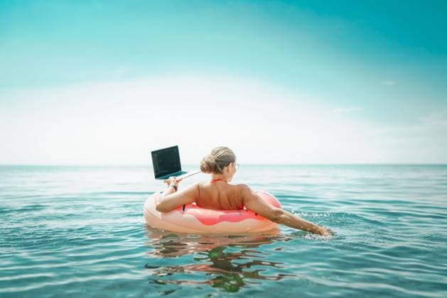 Woman laptop sea. Freelancer woman in sunglases floating on an inflatable big pink donut with a laptop in the sea. People summer vacation rest lifestyle concept Woman laptop sea. Freelancer woman in sunglases floating on an inflatable big pink donut with a laptop in the sea. People summer vacation rest lifestyle concept, model released, , 63322226.jpg RECORD DATE NOT STATED