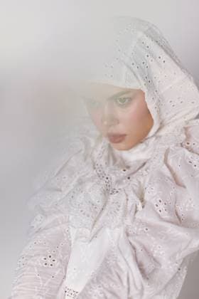 Elegant young model in a white lace hijab, showcasing serene emotions against a soft, blurred background, embodying purity and cultural beauty A graceful young woman in a white lace hijab displays calm emotions against a soft, blurred backdrop, representing cultural beauty and tranquility, model released, , 96310450.jpg RECORD DATE NOT STATED