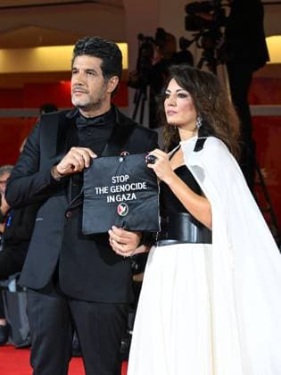 Venice, Italy: Venice, 82nd Venice International Film Festival 2025 - Evening 3 - The Red Carpet for the film Calle Malaga. Pictured: Stop the Genocide in Gaza: Nabil Ayouch, Maryam Touzani Venice Italy  - ZUMAp169 20250829_zea_p169_1328 Copyright: xManuelexMangiarottix
