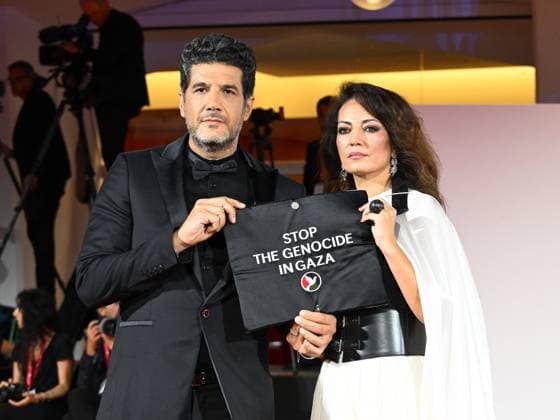 Venice, Italy: Venice, 82nd Venice International Film Festival 2025 - Evening 3 - The Red Carpet for the film Calle Malaga. Pictured: Stop the Genocide in Gaza: Nabil Ayouch, Maryam Touzani Venice Italy  - ZUMAp169 20250829_zea_p169_1330 Copyright: xManuelexMangiarottix