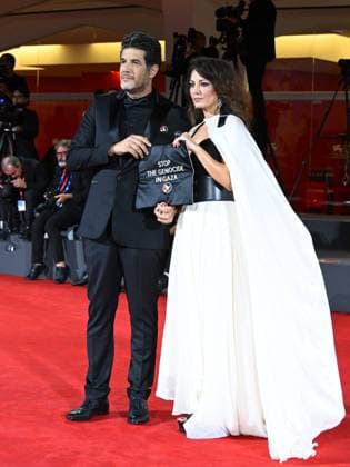 Venice, Italy: Venice, 82nd Venice International Film Festival 2025 - Evening 3 - The Red Carpet for the film Calle Malaga. Pictured: Stop the Genocide in Gaza: Nabil Ayouch, Maryam Touzani Venice Italy  - ZUMAp169 20250829_zea_p169_1333 Copyright: xManuelexMangiarottix