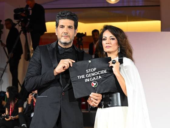 Venice, Italy: Venice, 82nd Venice International Film Festival 2025 - Evening 3 - The Red Carpet for the film Calle Malaga. Pictured: Stop the Genocide in Gaza: Nabil Ayouch, Maryam Touzani Venice Italy  - ZUMAp169 20250829_zea_p169_1361 Copyright: xManuelexMangiarottix
