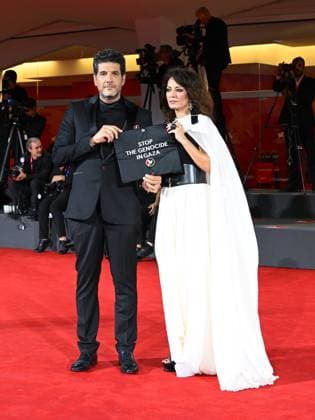 Venice, 82nd Venice International Film Festival 2025 - Evening 3 - The Red Carpet for the film Calle Malaga. Pictured: Stop the Genocide in Gaza: Nabil Ayouch, Maryam Touzani  Copyright: xManuelexMangiarottix xipa-agency.netx xPoolxPhotoxEventsx06x IPA_Agency_IPA63587611