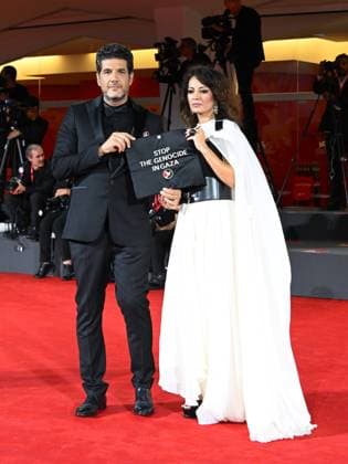 Venice, 82nd Venice International Film Festival 2025 - Evening 3 - The Red Carpet for the film Calle Malaga. Pictured: Stop the Genocide in Gaza: Nabil Ayouch, Maryam Touzani  Copyright: xManuelexMangiarottix xipa-agency.netx xPoolxPhotoxEventsx06x IPA_Agency_IPA63587609