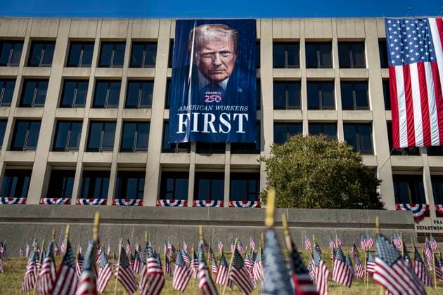 A portrait of President Donald Trump is draped on the front of the Department of Labor Headquarters in Washington, DC on Saturday, August 30, 2025. The banner, displayed next to a portrait of Teddy Roosevelt, features Trump s second inaugural portrait, the logo for his America 250 initiative, and the words American Workers First.  WAP20250830325 BONNIExCASH