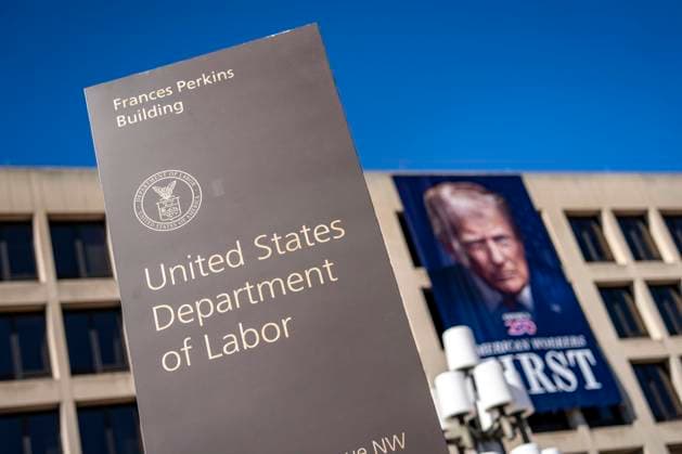 A portrait of President Donald Trump is draped on the front of the Department of Labor Headquarters in Washington, DC on Saturday, August 30, 2025. The banner, displayed next to a portrait of Teddy Roosevelt, features Trump s second inaugural portrait, the logo for his America 250 initiative, and the words American Workers First.  WAP20250830327 BONNIExCASH