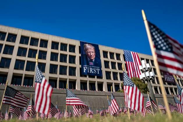 A portrait of President Donald Trump is draped on the front of the Department of Labor Headquarters in Washington, DC on Saturday, August 30, 2025. The banner, displayed next to a portrait of Teddy Roosevelt, features Trump s second inaugural portrait, the logo for his America 250 initiative, and the words American Workers First.  WAP20250830330 BONNIExCASH