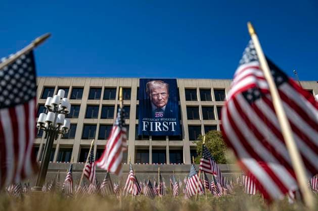 A portrait of President Donald Trump is draped on the front of the Department of Labor Headquarters in Washington, DC on Saturday, August 30, 2025. The banner, displayed next to a portrait of Teddy Roosevelt, features Trump s second inaugural portrait, the logo for his America 250 initiative, and the words American Workers First.  WAP20250830331 BONNIExCASH