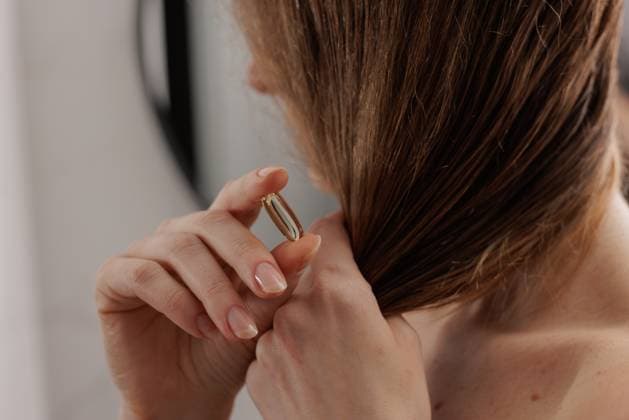 Close up of woman hand showing Omega 3 capsule for healthy hair, vitamins for hair care, Close up of woman hand showing Omega 3 capsule for healthy hair, vitamins for hair care, model released, , 63617556.jpg RECORD DATE NOT STATED