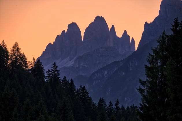 The south faces of the Tre Cime di Lavaredo in Tre Cime National Park, seen from the town of Auronzo di Cadore at sunset. Auronzo di Cadore Veneto Italy FB_2025_1483