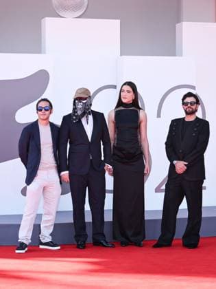 Venice, ITALY: Venice, 82nd Venice International Film Festival 2025 - evening 7 - red carpet of the film L Etranger (The Stranger) In the photo: Eric Kohn, Stillz, Arca and Esteban Zuluaga Venice ITALY  - ZUMAp169 20250902_zea_p169_1123 Copyright: xSimonexComix