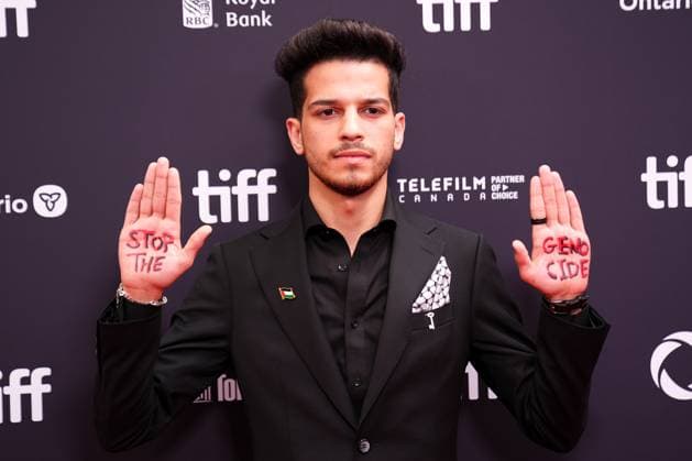 2025 Toronto International Film Festival - Palestine 36 TORONTO, CANADA - SEPTEMBER 5 : A guest, wearing pin of Palestine, poses with the words Stop the Genocide written on his hands during the premiere of ‘Palestine 36’ during the 2025 Toronto International Film Festival at Roy Thomson Hall in Toronto, Ontario, Canada on September 5, 2025. Mert Alper Dervis Anadolu Ontario Canada. Editorial use only. Please get in touch for any other usage.  Copyright: x2025xAnadoluxMertxAlperxDervisx