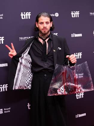 2025 Toronto International Film Festival - Palestine 36 TORONTO, CANADA - SEPTEMBER 5 : Actor Karim Daoud Anaya wearing pin of Palestine and keffiyeh, hold a camera painted red during the premiere of ‘Palestine 36’ during the 2025 Toronto International Film Festival at Roy Thomson Hall in Toronto, Ontario, Canada on September 5, 2025. Mert Alper Dervis Anadolu Ontario Canada. Editorial use only. Please get in touch for any other usage.  Copyright: x2025xAnadoluxMertxAlperxDervisx