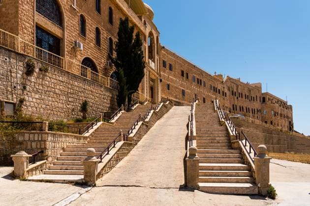 MR_ID30073_22372_JavierBallester.jpg The historic Marmatai Monastery in Iraq features grand stone steps leading to its entrance, framed by clear blue skies. Its architecture showcases ancient charm and spiritual heritage. Model Released JavierBallester_ID30073_1015115_040 Copyright: xJavierxBallesterx
