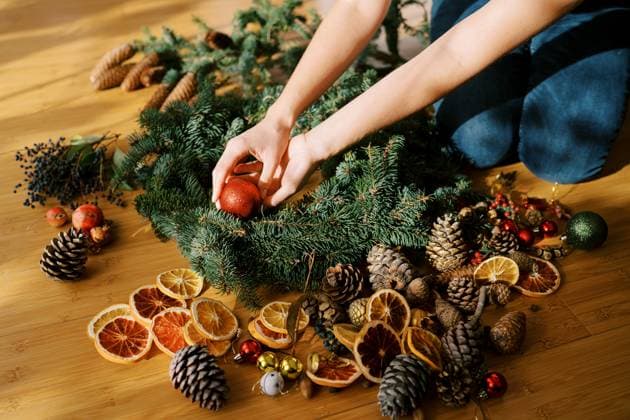 Designer is arranging the Christmas wreath while sitting on the floor. Cropped. Faceless Designer is arranging the Christmas wreath while sitting on the floor. Cropped. Faceless. High quality photo, model released, , 95796486.jpg RECORD DATE NOT STATED