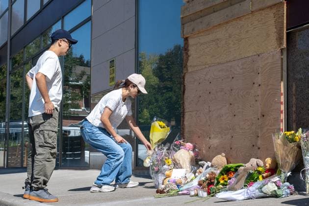 September 11, 2025, Richmond Hill, On, Canada: A woman is seen placing flowers in front of a damaged window the day after an SUV crashed into a daycare in Richmond Hill, Ont., on Thursday, Sept. 11, 2025. Richmond Hill Canada  - ZUMAc35_ 20250911_zaf_c35_040 Copyright: xEduardoxLimax