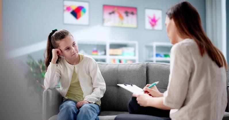 Psychiatrist comforting sad ADHD child during counseling therapy Psychiatrist comforting sad ADHD child during counseling therapy session., model released, , 94775270.jpg RECORD DATE NOT STATED