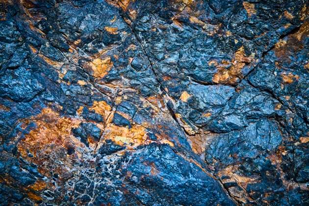 Colorful Eroded Rock Textures Eye-Level Close-Up Discover the rugged beauty of Bootleg Canyon in Boulder City, Nevada. This close-up of a rocky surface showcases vibrant blue and rusty orange hues, revealing nature s intricate patterns and textures., 65190062.jpg RECORD DATE NOT STATED