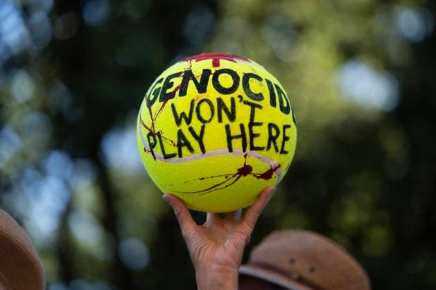 September 12, 2025, Halifax, Ns, Canada: A demonstrator holds a large tennis ball splashed with red paint as people protest Team Israel s participation in the Davis Cup tennis match against Team Canada in Halifax on Friday, Sept. 12, 2025. Halifax Canada  - ZUMAc35_ 20250912_zaf_c35_054 Copyright: xDarrenxCalabresex