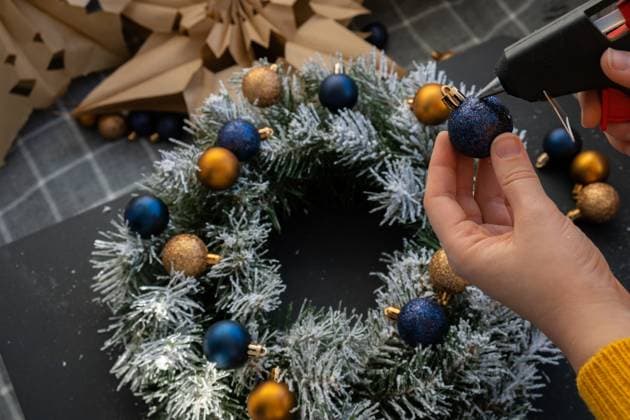 Crafter using hot glue DIY process of woman making Christmas arrangement with decor of blue and yellow colors. Small business, self employed entrepreneur, self-made career. Series of handmade craft instruction. Zero waste eco-friendly winter holiday decoration Crafter using hot glue DIY process of woman making Christmas arrangement with decor of blue and yellow colors. Small business, self employed entrepreneur, self-made career. Series of handmade craft instruction. Zero waste eco-friendly winter holiday decoration. New year, 97008632.jpg RECORD DATE NOT STATED
