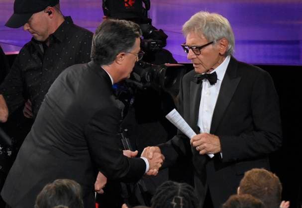 Stephen Colbert speaks to Harrison Ford at the 77th annual Primetime Emmy Awards at the Peacock Theater in Los Angeles on Sunday, September 14, 2025.  LAP202509142002 JIMxRUYMEN