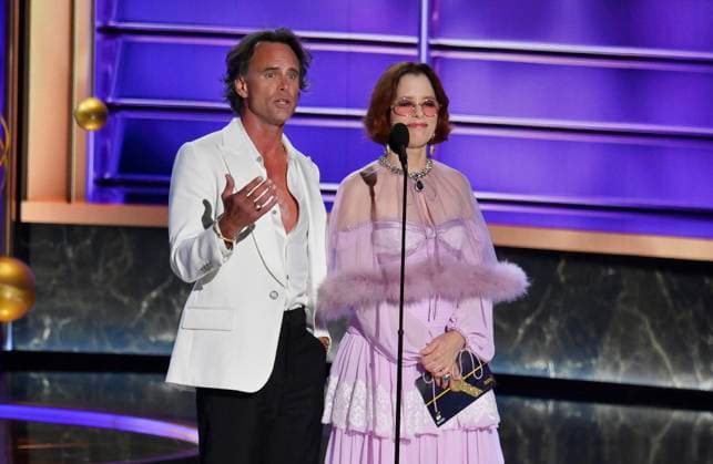 Walton Goggins and Parker Posey speak onstage at the 77th annual Primetime Emmy Awards at the Peacock Theater in Los Angeles on Sunday, September 14, 2025.  LAP202509148030 JIMxRUYMEN