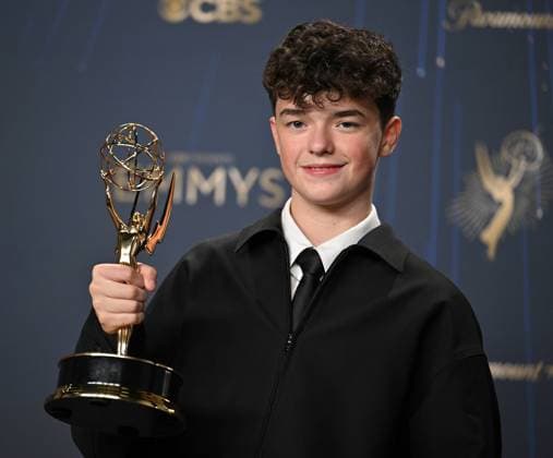Owen Cooper holds the Emmy for Outstanding Supporting Actor in a Limited or Anthology Series or Movie for Adolescence, backstage during the 77th annual Primetime Emmy Awards at the Peacock Theater in Los Angeles on Sunday, September 14, 2025.  LAP20250914186 CHISxCHEW
