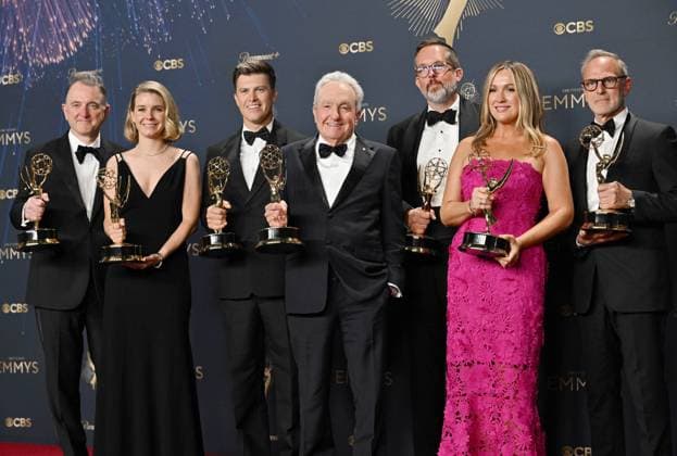 (L-R) Javier Winnik, Caroline Maroney, Colin Jost, Lorne Michaels, Erik Kenward, Erin Doyle, and Tom Broecker hold the Emmy for Outstanding Variety Special for SNL50: The Anniversary Special, backstage during the 77th annual Primetime Emmy Awards at the Peacock Theater in Los Angeles on Sunday, September 14, 2025.  LAP20250914205 CHISxCHEW