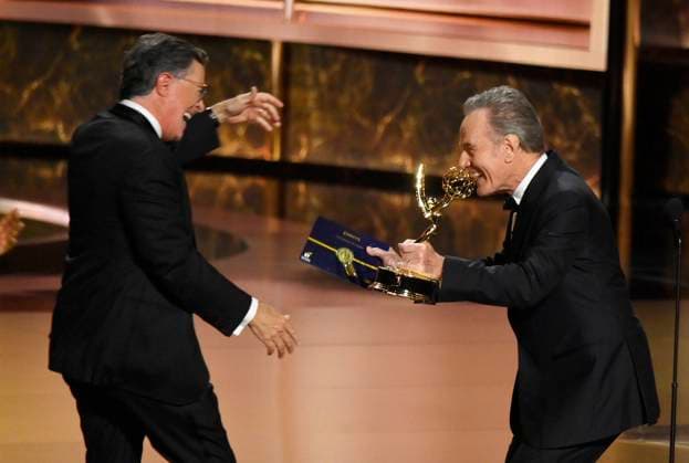 Bryan Cranston hands Stephen Colbert the Outstanding Talk Series Award for The Late Show with Stephen Colbert onstage at the 77th annual Primetime Emmy Awards at the Peacock Theater in Los Angeles on Sunday, September 14, 2025.  LAP2025091430706 JIMxRUYMEN