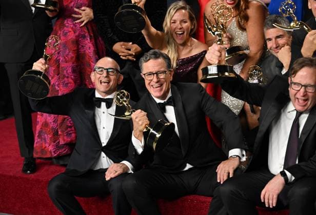 Stephen Colbert (C) holds the Emmy for Outstanding Talk Series award for The Late Show with Stephen Colbert, backstage during the 77th annual Primetime Emmy Awards at the Peacock Theater in Los Angeles on Sunday, September 14, 2025.  LAP20250914304 CHISxCHEW