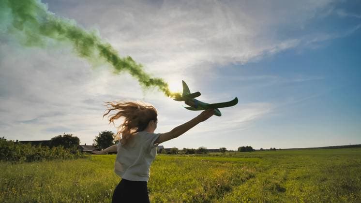 A young girl with a toy airplane smokes colorful smoke on a summer evening. A young girl with a toy airplane smokes colorful smoke on a summer evening, model released, , 95801254.jpg RECORD DATE NOT STATED