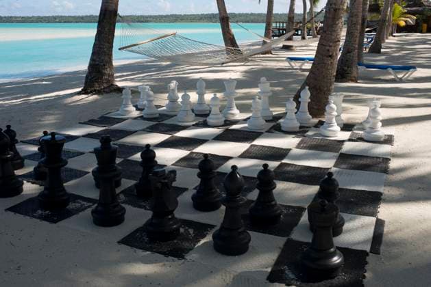 Cook Islands in the South Pacific Aitutaki. Cook Island. Polynesia. South Pacific Ocean. Giant chess set on the beach of the Aitutaki Lagoon Resort & Spa Hotel. With a lagoon that is arguably one of the most beautiful in the world, a cruise out on its pristine water is an absolute must. You are likely to be so enchanted, that you ll book another tour for the next day. Back on land, the island of Aitutaki has an interesting history and there are excavations of local marae underway. You can take a safari tour to these ancient places, explore the island and also find out about the legacy of the American troops stationed here during WWII. For novice scooter riders, Aitutaki is generally safer than Rarotonga where traffic can be quite busy at ti Copyright: xSergixReboredox