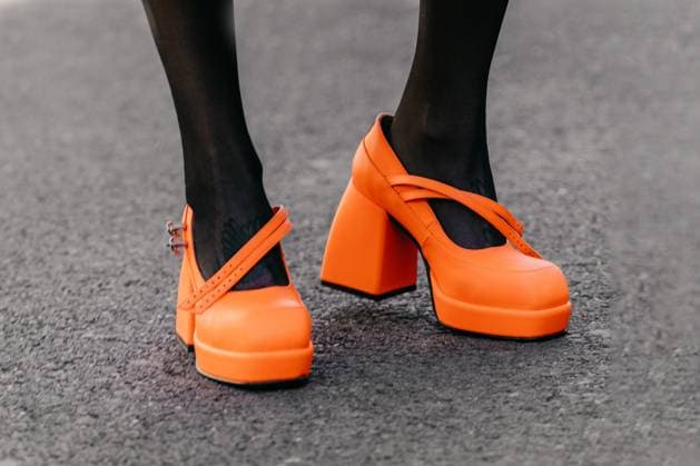 RECORD DATE NOT STATED Milan, Italy - February, 23, 2022: woman wears orange high heel shoes Milan, Italy - February, 23, 2022: woman wears orange high heel shoes, street style details, 96472620.jpg