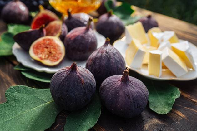 Cheese platter with camembert brie, healthy juicy organic figs, honey and grapes Cheese platter with camembert brie, healthy juicy organic figs, honey and grapes. Red wine glass, appetizer set. Seasonal fruits, 96035500.jpg RECORD DATE NOT STATED