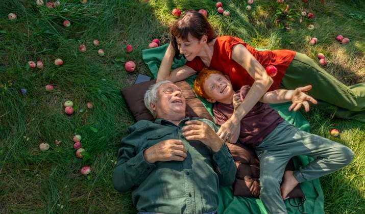 Family enjoying time together lying on grass in garden with apples model released, Symbolfoto, MBLF01025