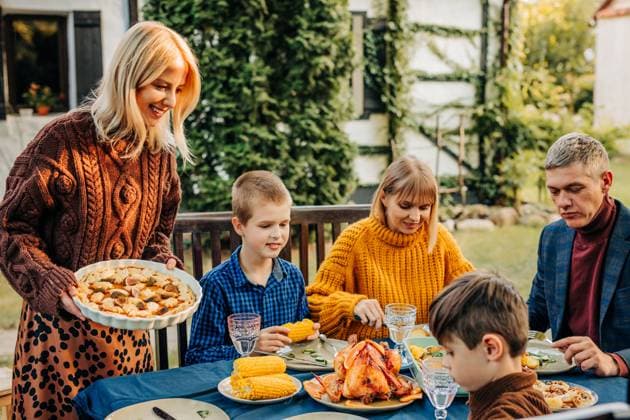 Family enjoying thanksgiving dinner outdoors in rural autumn setting model released, Symbolfoto property released, VSNF04149