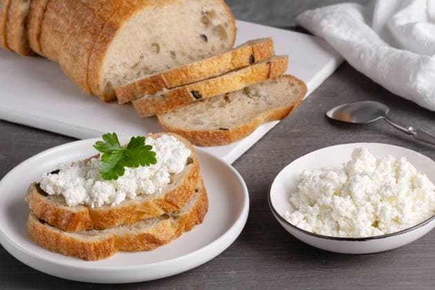 Home made bread on a wooden cutting board with curd cheese Home made bread on a wooden cutting board with curd cheese., 60086800.jpg RECORD DATE NOT STATED