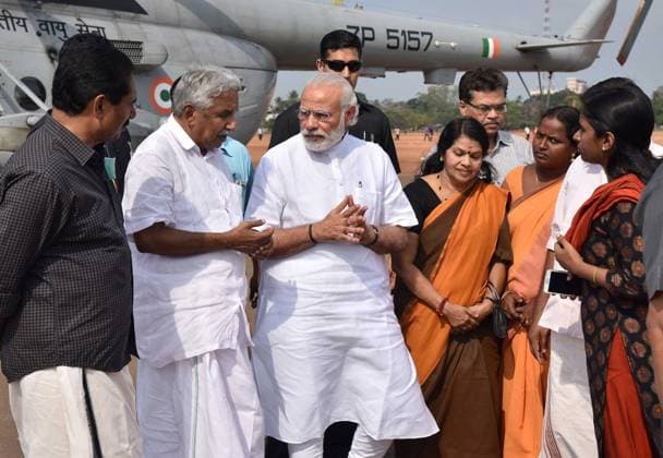Indian Prime Minister Modi Visits Temple Disaster in Kerala April 10, 2016 - Kollam, Kerala, India - Indian Prime Minister Narendra Modi is greeted by Kerala Chief Minister Oommen Chandy on arrival to visit the destruction at the Puttingal Temple Paravur April 10, 2016 in Kollam, Kerala, India. At least 100 people were killed and 500 injured after a fireworks display exploded during a Hindu New Year festival. Copyright: xPressxInformationxBureaux