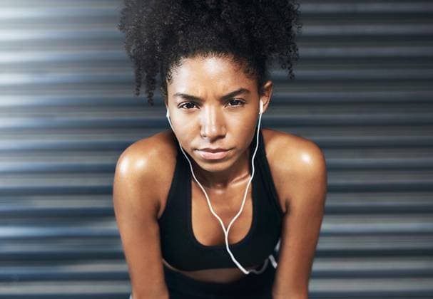 Rest, portrait and woman with earphones in gym with music for workout, training and exercise. Sports center, fitness and person listening to audio, playlist and radio for health, wellness and break. model released property released Copyright: xwww.peopleimages.comx