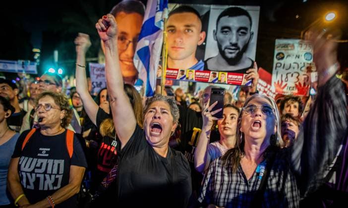 September 30, 2025, Tel Aviv, Israel: Israeli protestors gesture as they chant and hold a placard showing Israeli hostage Matan Angriest during a demonstration. Parents of Israeli combat soldiers marched from the military headquarters to Likud headquarters, demanding an immediate end to the Gaza war. The protest followed a press conference in which Prime Minister Netanyahu and U.S. President Donald Trump announced a ceasefire and hostage-release deal. In response, Hamas said it would study the plan before issuing its reaction, while Trump gave the group three to four days to accept the proposal or face serious consequences. Tel Aviv Israel - ZUMAs197 20250930_aaa_s197_325 Copyright: xEyalxWarshavskyx