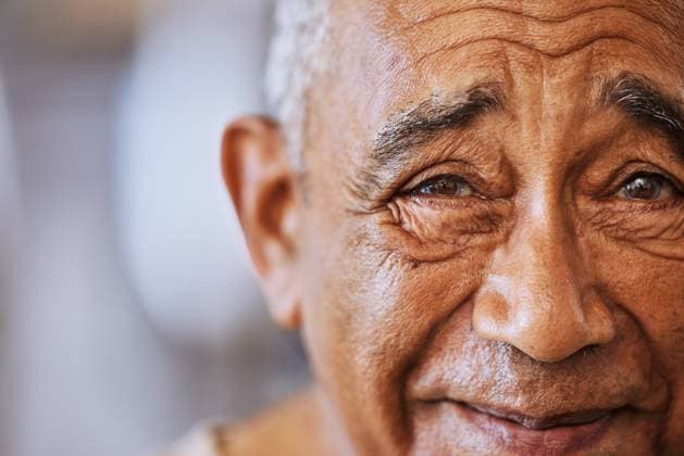 Portrait of a happy, kind black senior mans face with wrinkles, smile and friendly in a retirement home. Happiness, joy and positive elderly black man smiling and feeling content with retired life. model released property released Copyright: xwww.peopleimages.comx