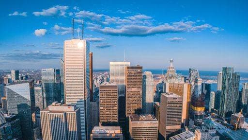 Aerial view of Torontos skyline with modern skyscrapers under a vibrant blue sky. 34980788 RECORD DATE NOT STATED