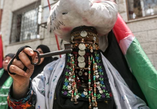 74th Nakba Day in Gaza, Palestine - 15 May 2022 May 15, 2022, Gaza, Palestine: A Palestinian woman holds a key during a march to commemorate the 74th anniversary of the Nakba in Gaza City. The anniversary of the Nakba falls on May 15 of every year, the day of the establishment of the State of Israel in 1948. Copyright: xYousefxMasoudx