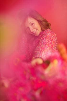 Woman in Pink Sweater with Pink Flowers and Pink Backdrop Tulsa, Oklahoma, United States CR_KRRY251009-1849474-01 ,model released, Symbolfoto