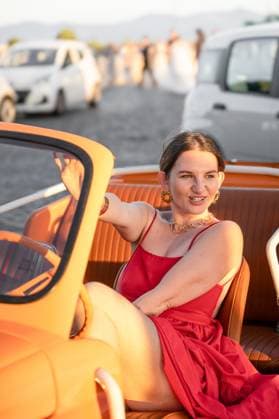 Woman in red dress sitting in vintage convertible car at sunset Rome, Lazio, Italy R_PJJZ251010B-1857040-01 ,model released, Symbolfoto