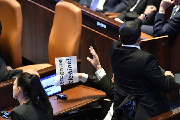 251013 -- JERUSALEM, Oct. 13, 2025 -- An Israeli Knesset member displays a sign calling for the recognition of Palestine during Trump s speech in Israeli parliament, the Knesset, in Jerusalem on Oct. 13, 2025. U.S. President Donald Trump addressed the Israeli parliament, the Knesset, on Monday during a brief visit as the Israel-Hamas ceasefire entered its fourth day, hailing an end to Israel s two-year war in Gaza. Trump s speech was briefly interrupted when a Knesset member displayed a sign calling for the recognition of Palestine. JINI via Xinhua MIDEAST-JERUSALEM-KNESSET-TRUMP JixNitupianshe  MIDEAST-JERUSALEM-KNESSET-TRUMP IMAGO JixNitupianshe  imago images 1067744426