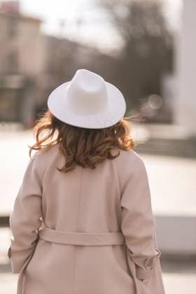 Back view of happy woman wearing hat and coat walking down street on sunny spring day. People, lifestyle, travel and vacations concept Back view of happy woman wearing hat and coat walking down street on sunny spring day. People, lifestyle, travel and vacations concept., model released, , 60107992.jpg RECORD DATE NOT STATED