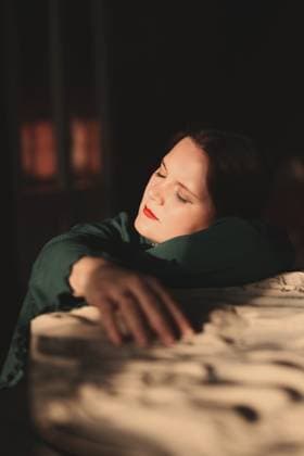 Woman resting peacefully with hand on stone surface in warm light Saint Petersburg, Saint Petersburg, Russia R_KNCD251013G-1856347-01 ,model released, Symbolfoto