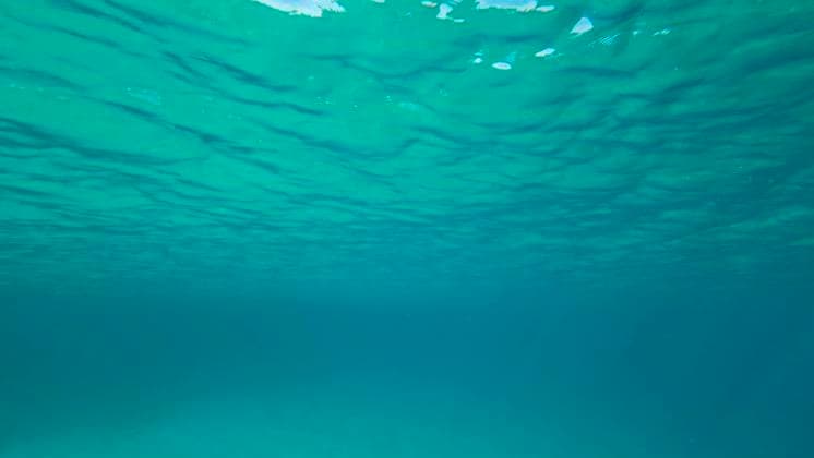 Surface of blue water. Natural background with sun glints on surface of blue water. Texture of blue water surface of sea reflection of sun s rays. Underwater shot. Red sea, Egypt June 23, 2022, Red Sea, Egypt: Surface of blue water. Natural background with sun glints on surface of blue water. Texture of blue water surface of sea reflection of sun s rays. Underwater shot. Red sea, Egypt Copyright: xAndreyxNekrasovx